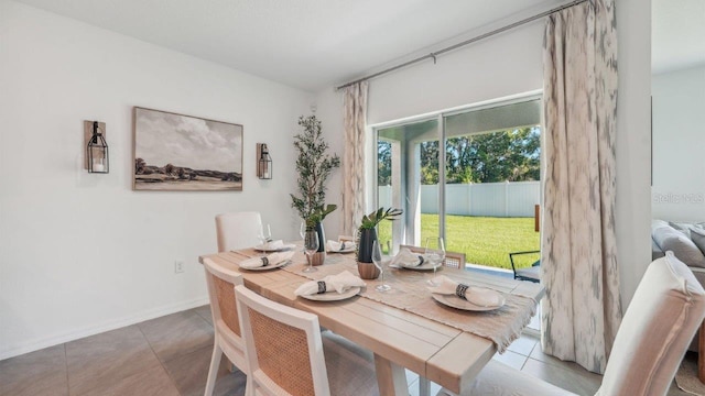 dining space featuring tile patterned flooring and baseboards