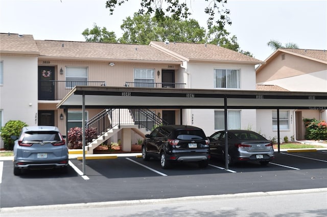covered parking lot featuring stairs