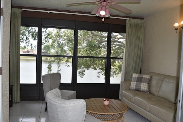 tiled living room featuring ceiling fan and plenty of natural light
