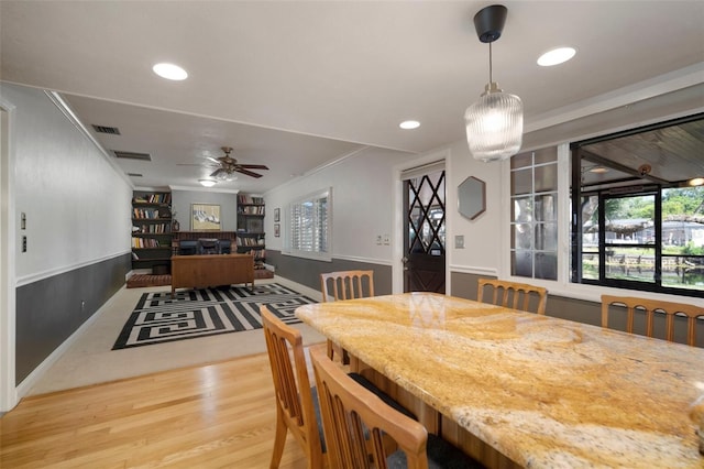 dining space with wood finished floors, ceiling fan, baseboards, recessed lighting, and crown molding