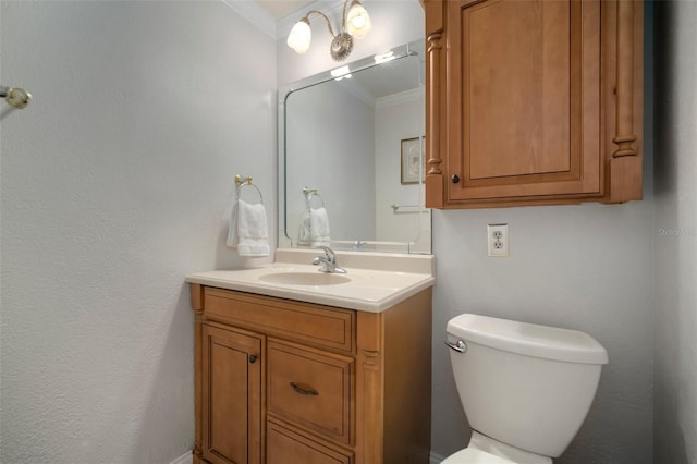 bathroom featuring crown molding, vanity, and toilet