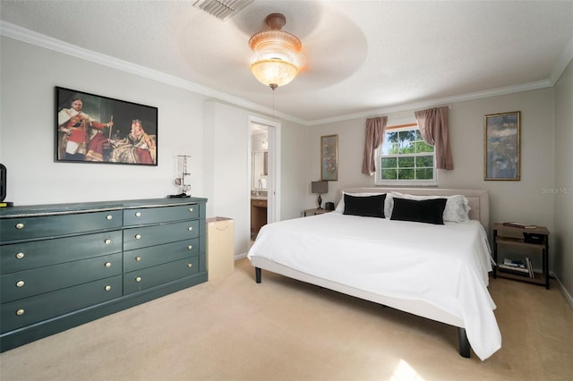 carpeted bedroom featuring ornamental molding, ensuite bathroom, ceiling fan, and baseboards