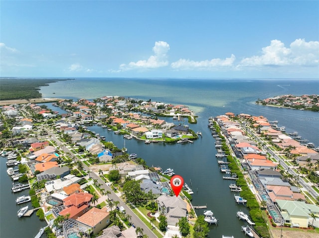 aerial view of residential area featuring a nearby body of water