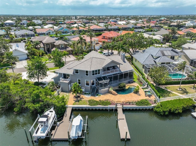 aerial perspective of suburban area with a pool area and a large body of water