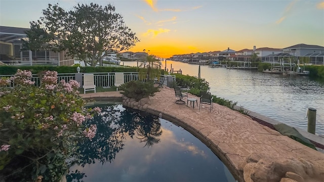 water view featuring nearby suburban area and fence