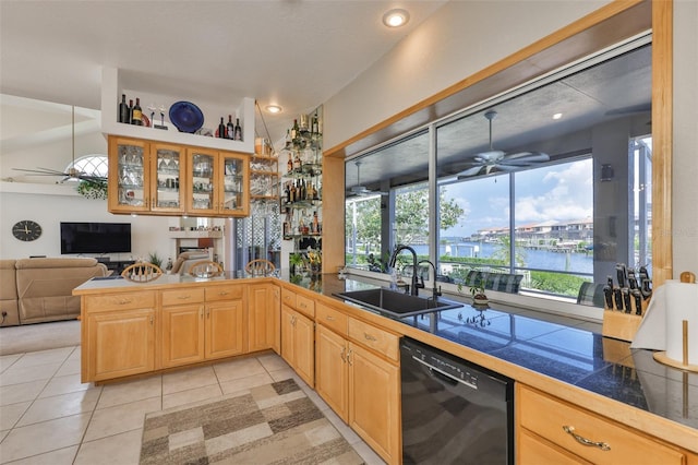 kitchen with dishwasher, ceiling fan, a sink, glass insert cabinets, and light tile patterned flooring