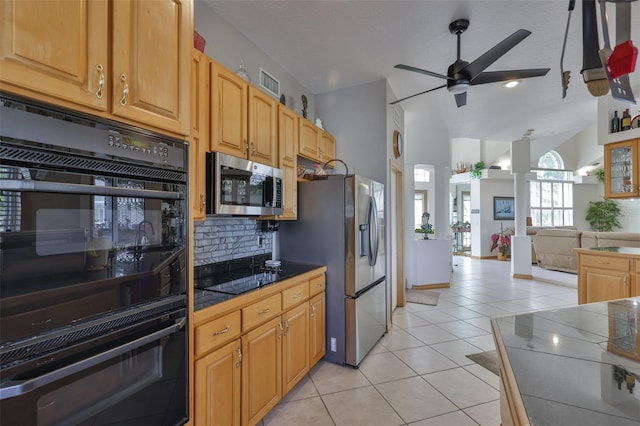 kitchen featuring black appliances, light tile patterned floors, ceiling fan, backsplash, and tile counters