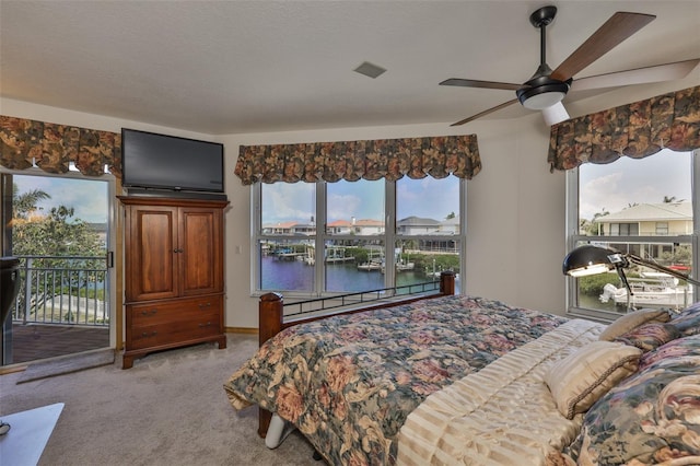 bedroom featuring access to outside, light carpet, and ceiling fan