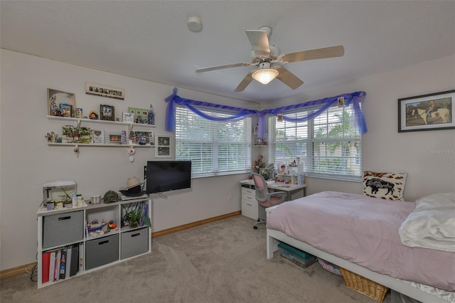 carpeted bedroom featuring a ceiling fan and baseboards
