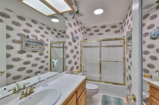 bathroom featuring wallpapered walls, vanity, toilet, tile patterned flooring, and enclosed tub / shower combo