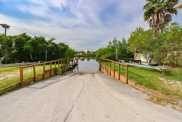 view of road with a boat ramp and a water view