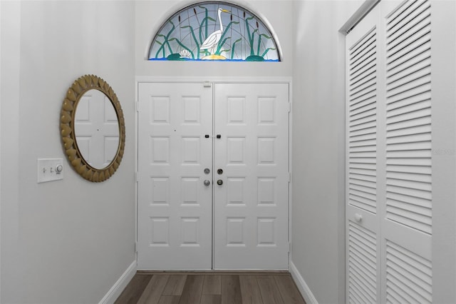 entrance foyer featuring baseboards and wood finished floors