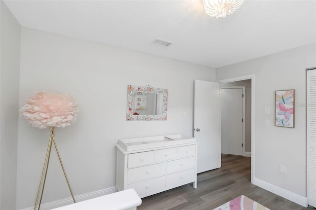 bedroom featuring wood finished floors and baseboards