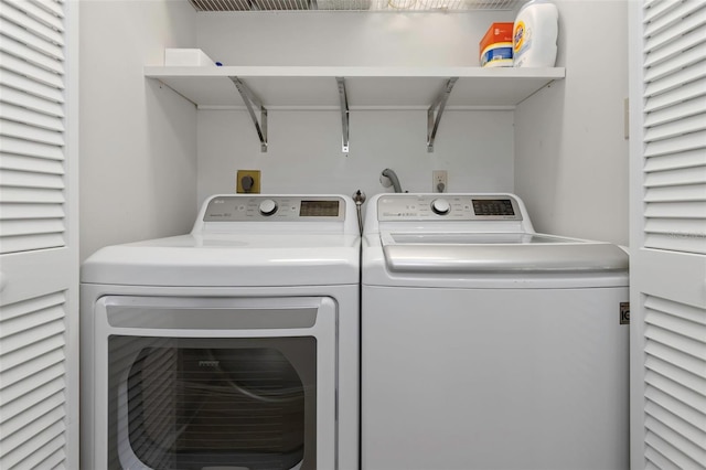 clothes washing area featuring washer and dryer