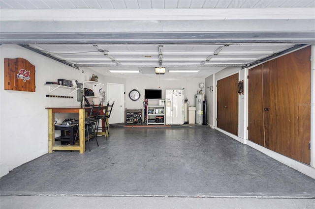 garage featuring white refrigerator with ice dispenser, electric water heater, and a garage door opener