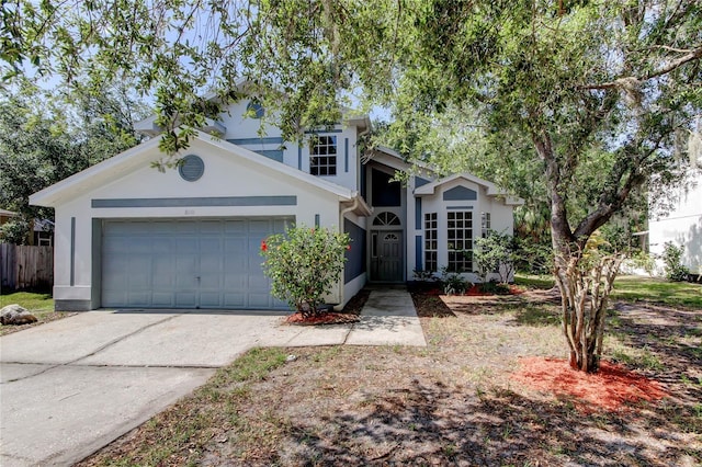 8110 Pond Shadow Ln, Tampa, FL 33635 - traditional home featuring a garage, stucco siding, driveway, and fence