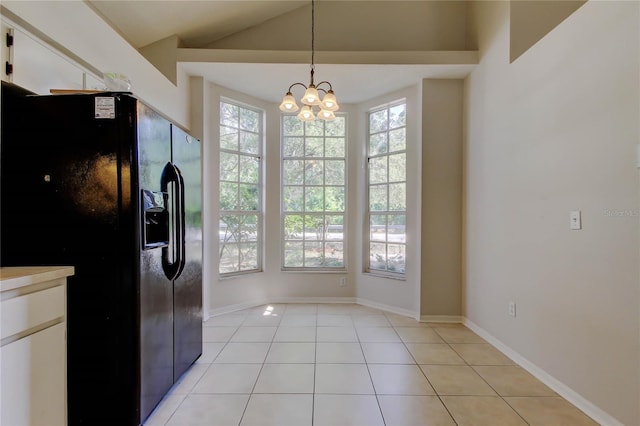 8110 Pond Shadow Ln, Tampa, FL 33635 - unfurnished dining area featuring light tile patterned flooring, lofted ceiling, a chandelier, and baseboards