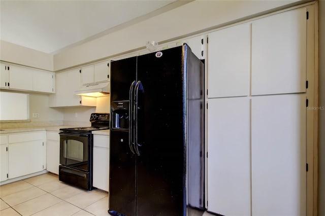 8110 Pond Shadow Ln, Tampa, FL 33635 - kitchen with black appliances, under cabinet range hood, light tile patterned floors, light countertops, and white cabinetry