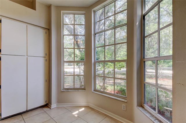 8110 Pond Shadow Ln, Tampa, FL 33635 - entryway with light tile patterned floors, plenty of natural light, and baseboards