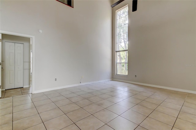 8110 Pond Shadow Ln, Tampa, FL 33635 - empty room featuring light tile patterned floors, healthy amount of natural light, a ceiling fan, and baseboards