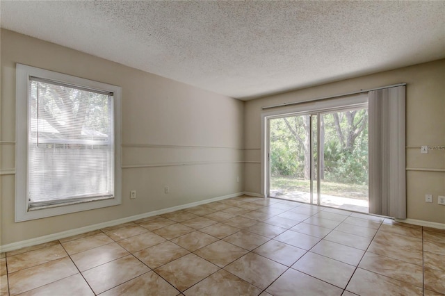 8110 Pond Shadow Ln, Tampa, FL 33635 - empty room featuring a textured ceiling and light tile patterned floors