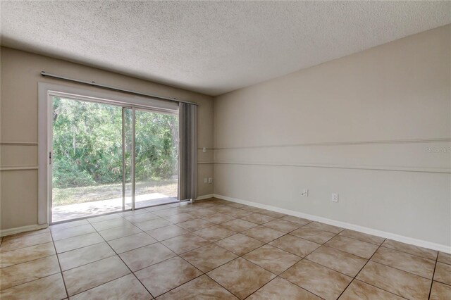 8110 Pond Shadow Ln, Tampa, FL 33635 - empty room with a textured ceiling, light tile patterned flooring, and baseboards