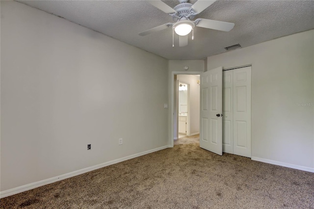 8110 Pond Shadow Ln, Tampa, FL 33635 - unfurnished bedroom with carpet flooring, baseboards, a textured ceiling, a closet, and ceiling fan