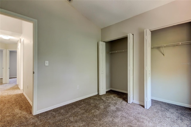 8110 Pond Shadow Ln, Tampa, FL 33635 - unfurnished bedroom featuring carpet flooring, two closets, baseboards, and vaulted ceiling