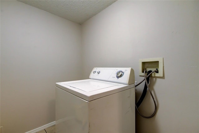 8110 Pond Shadow Ln, Tampa, FL 33635 - clothes washing area featuring washer / clothes dryer, a textured ceiling, and baseboards