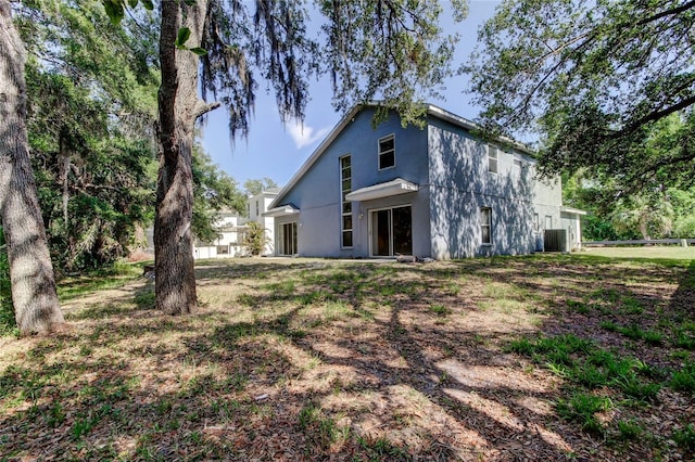 8110 Pond Shadow Ln, Tampa, FL 33635 - rear view of property featuring central air condition unit and stucco siding