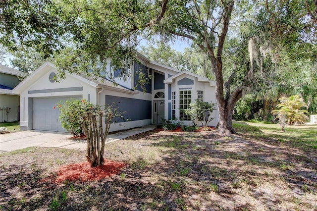 8110 Pond Shadow Ln, Tampa, FL 33635 - view of front facade featuring stucco siding, a garage, and driveway