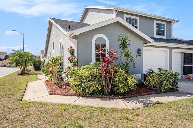 4270 Boston Cir, New Port Richey, FL 34653 - view of front of property featuring stucco siding, a front lawn, and a garage