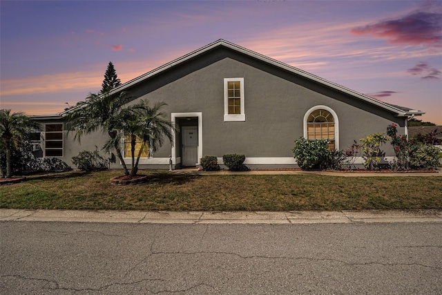 4270 Boston Cir, New Port Richey, FL 34653 - view of front of home with stucco siding and a lawn