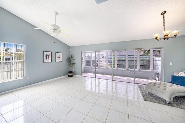 4270 Boston Cir, New Port Richey, FL 34653 - unfurnished living room featuring a chandelier, ceiling fan, a textured ceiling, light tile patterned floors, and high vaulted ceiling