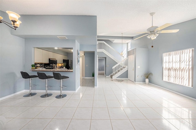 4270 Boston Cir, New Port Richey, FL 34653 - living room with stairs, light tile patterned flooring, ceiling fan, and baseboards