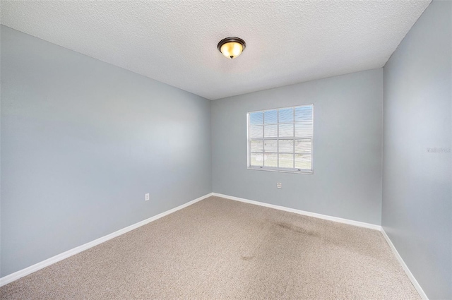 4270 Boston Cir, New Port Richey, FL 34653 - empty room featuring carpet floors, baseboards, and a textured ceiling