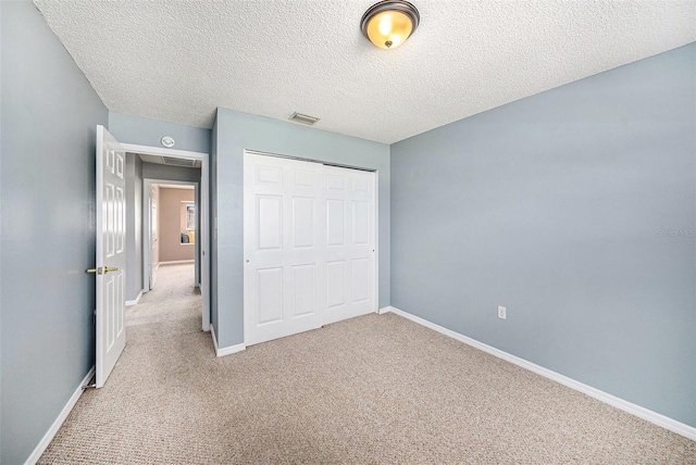 4270 Boston Cir, New Port Richey, FL 34653 - unfurnished bedroom with carpet flooring, a closet, baseboards, and a textured ceiling