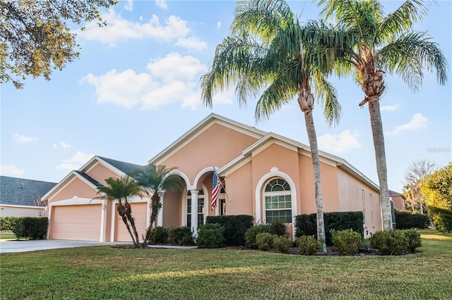 7533 Dunbridge Dr, Odessa, FL 33556 - mediterranean / spanish-style home with stucco siding, concrete driveway, a front lawn, and a garage