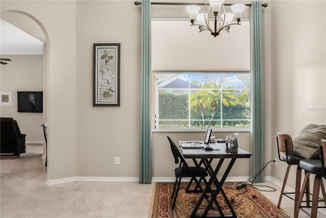 7533 Dunbridge Dr, Odessa, FL 33556 - dining room featuring a chandelier, arched walkways, and baseboards