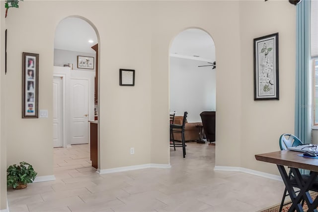 7533 Dunbridge Dr, Odessa, FL 33556 - corridor featuring arched walkways, baseboards, and a desk