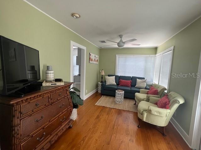 3031 56th St S, Gulfport, FL 33707 - living area with baseboards, wood finished floors, and ceiling fan