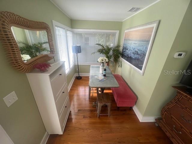 3031 56th St S, Gulfport, FL 33707 - dining space featuring baseboards, wood finished floors, and ornamental molding