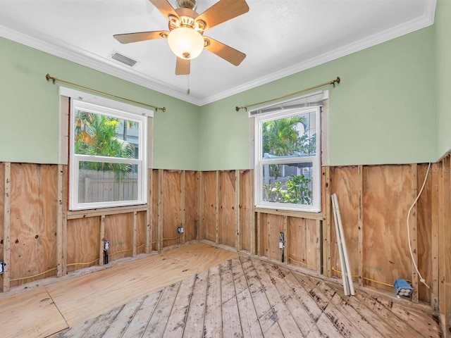 3031 56th St S, Gulfport, FL 33707 - unfurnished room featuring wooden walls, wainscoting, hardwood / wood-style floors, ornamental molding, and ceiling fan