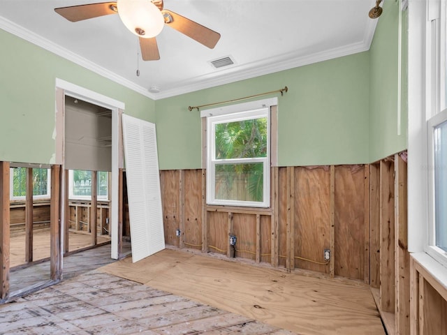 3031 56th St S, Gulfport, FL 33707 - unfurnished room featuring wainscoting, hardwood / wood-style floors, ornamental molding, ceiling fan, and wood walls