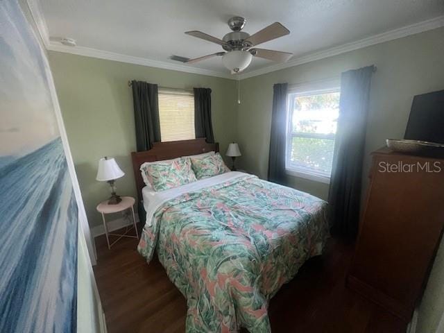 3031 56th St S, Gulfport, FL 33707 - bedroom with crown molding, wood finished floors, ceiling fan, and baseboards
