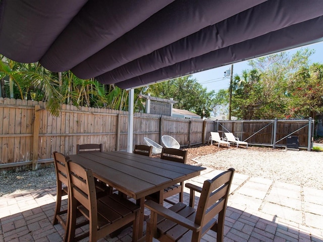 3031 56th St S, Gulfport, FL 33707 - view of patio featuring a fenced backyard and outdoor dining space