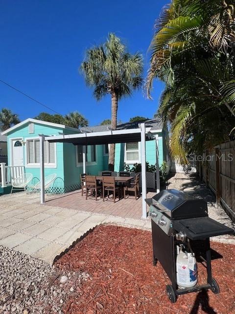 3031 56th St S, Gulfport, FL 33707 - back of property featuring a fenced backyard and a patio area