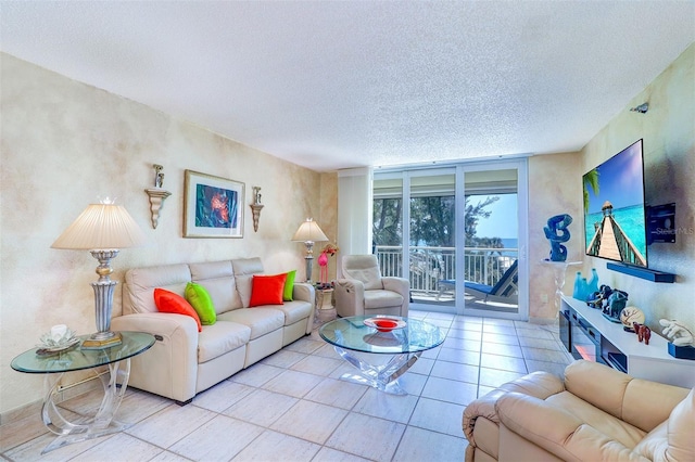2504 Gulf Blvd Unit 201, Indian Rocks Beach, FL 33785 - living area with a textured ceiling, floor to ceiling windows, and tile patterned flooring