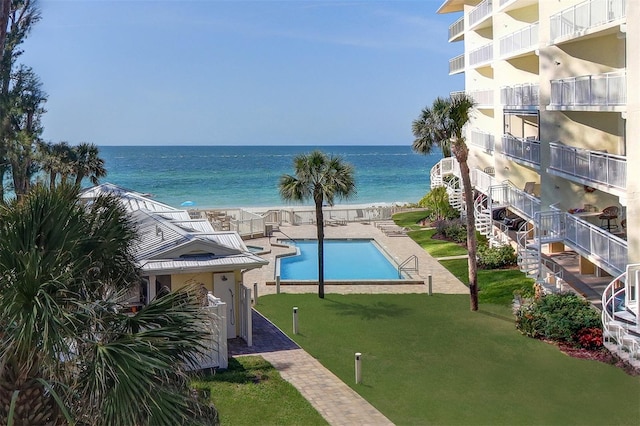 2504 Gulf Blvd Unit 201, Indian Rocks Beach, FL 33785 - community pool featuring a water view, a yard, and stairs
