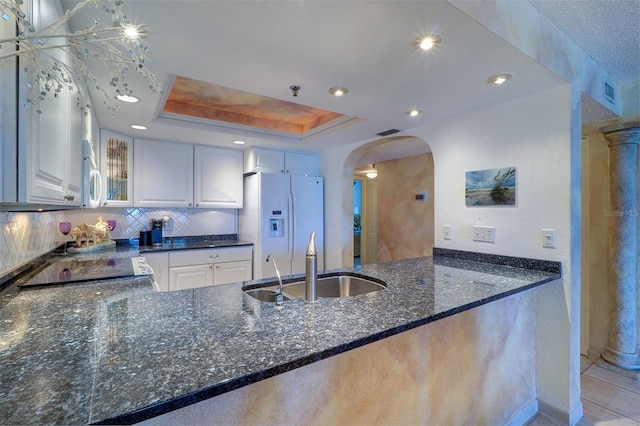 2504 Gulf Blvd Unit 201, Indian Rocks Beach, FL 33785 - kitchen with white appliances, a peninsula, a sink, arched walkways, and recessed lighting
